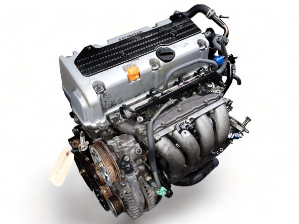 Honda engine with black valve cover, silver intake manifold, and visible pulleys on white background