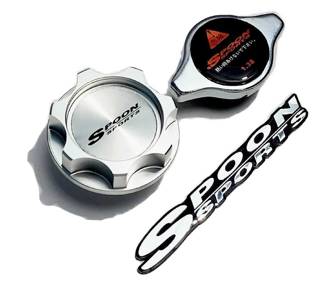 Spoon Sports silver oil cap, radiator cap, and logo badge on white background