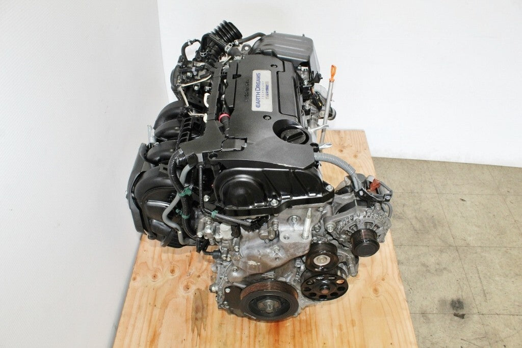 Honda Earth Dreams engine on wooden platform, automotive engine components visible