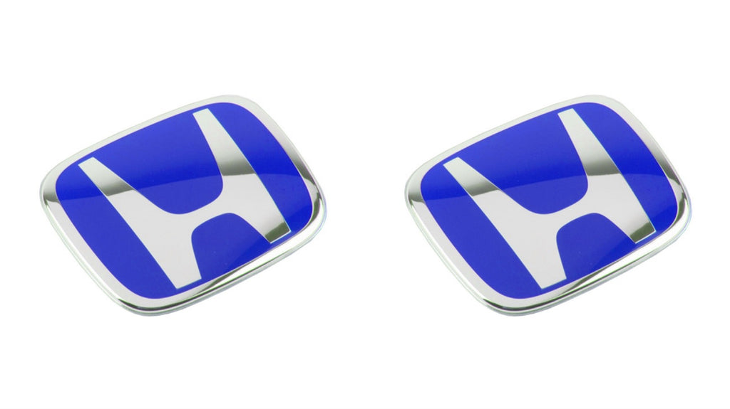 Pair of blue chrome Honda car emblems with white H logo on white background
