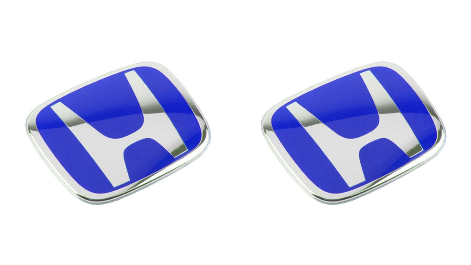 Pair of blue Honda car emblems with chrome trim on white background