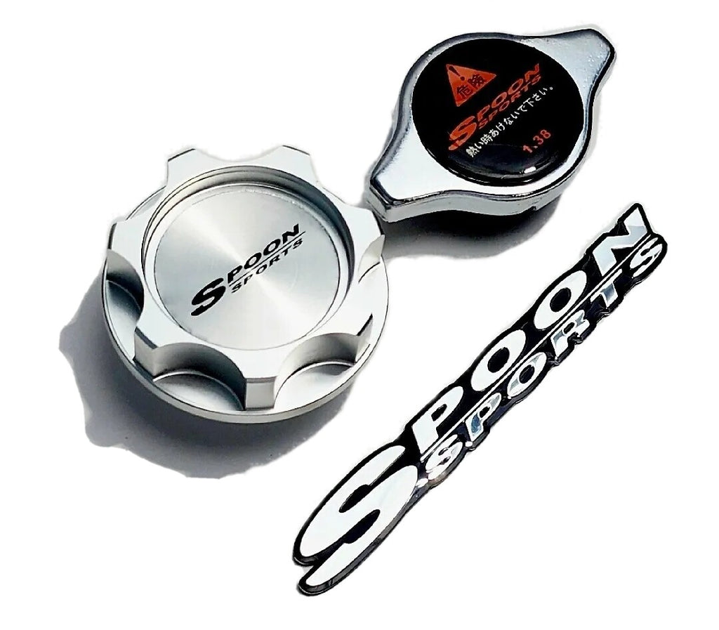 Spoon Sports silver oil cap, radiator cap, and chrome emblem on white background