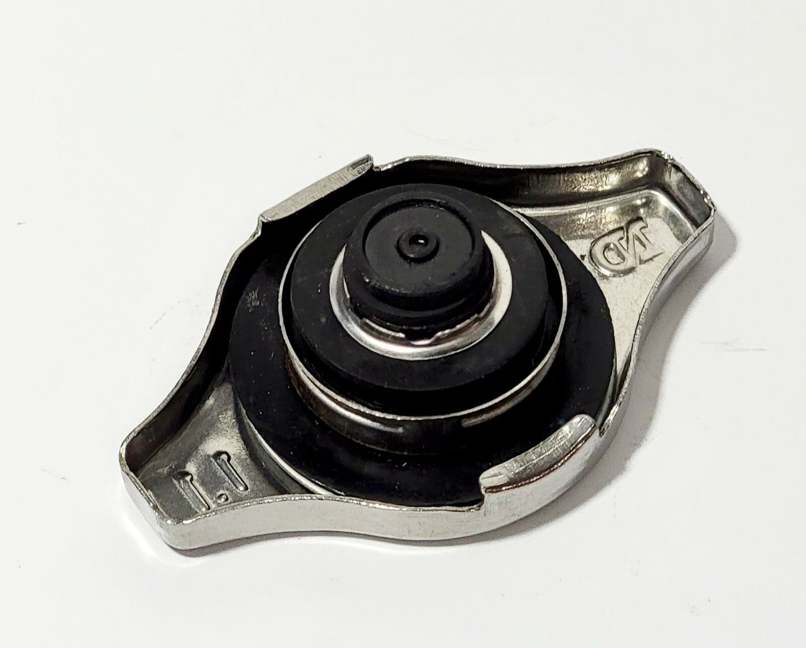 Metal radiator cap with rubber gasket on white background, automotive car part